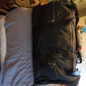 Coach black wheeled duffle bag